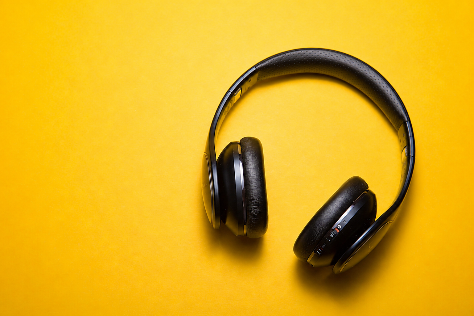 Headphones on a yellow background, after light, color and clarity